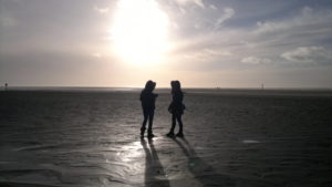 a group of people standing on a beach